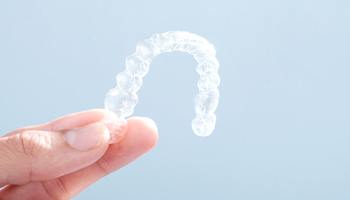 hand holding Invisalign