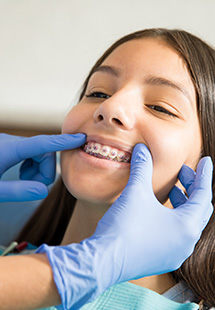 Patient smiling with traditional braces in Grandview Heights