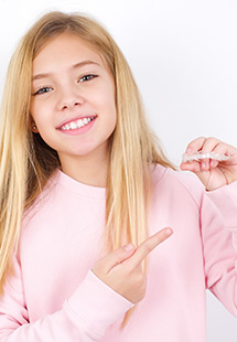 Teen pointing to Invisalign in Grandview Heights