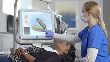 Dentist and patient looking at digital impression