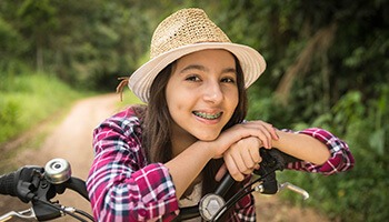 Young girl on bike wearing braces