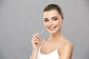 Confident young woman enjoying the benefits of Invisalign