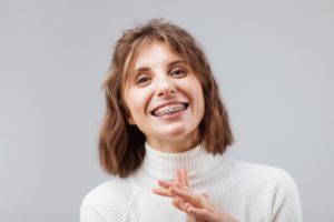 Woman with braces, thinking about braces treatment time